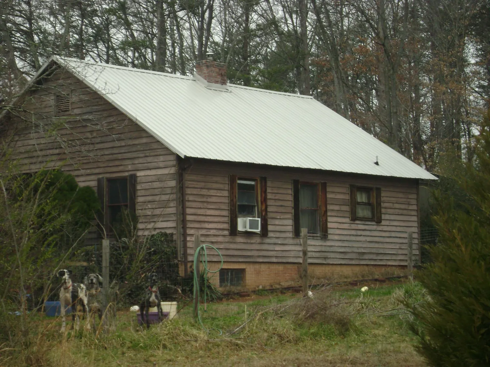 White metal roof on an old wood sided farmhouse, from a Metal Roof Installation job in Canton Center